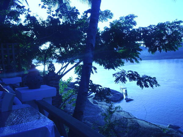 Watching the sunset while having dinner beside the Mekong