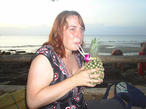 Kate drinks out of a pineapple