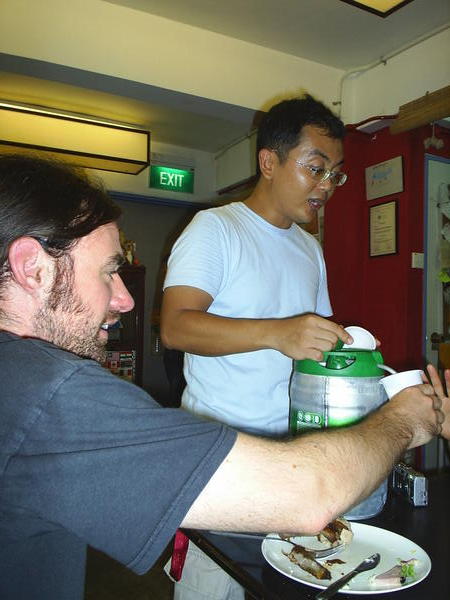 Tony the hostel owner dishes out frothy beer to accompany our meal