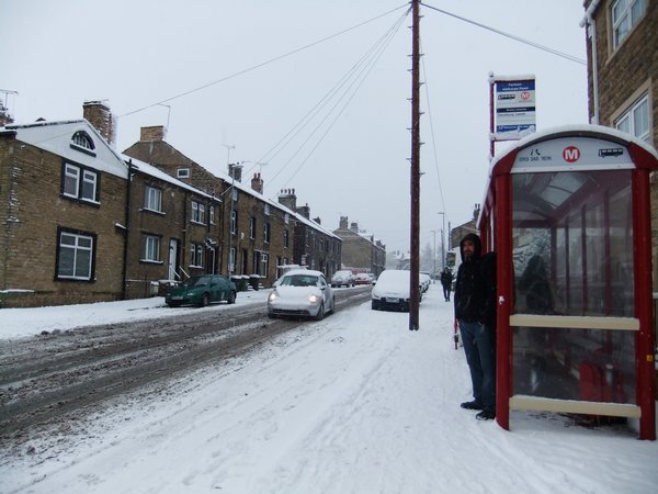 Kris at a bus stop in snowy Pudsey