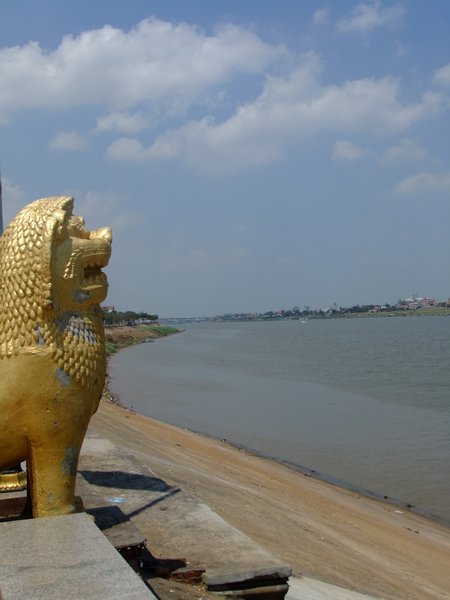 A lion looks over at the end of the Tonle Sap lake/river