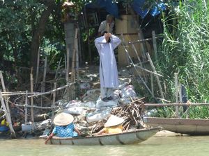 Man praying at the fishing village in Hue