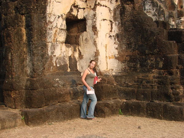 Standing in front of a magnificent ruin at Wat San Khao