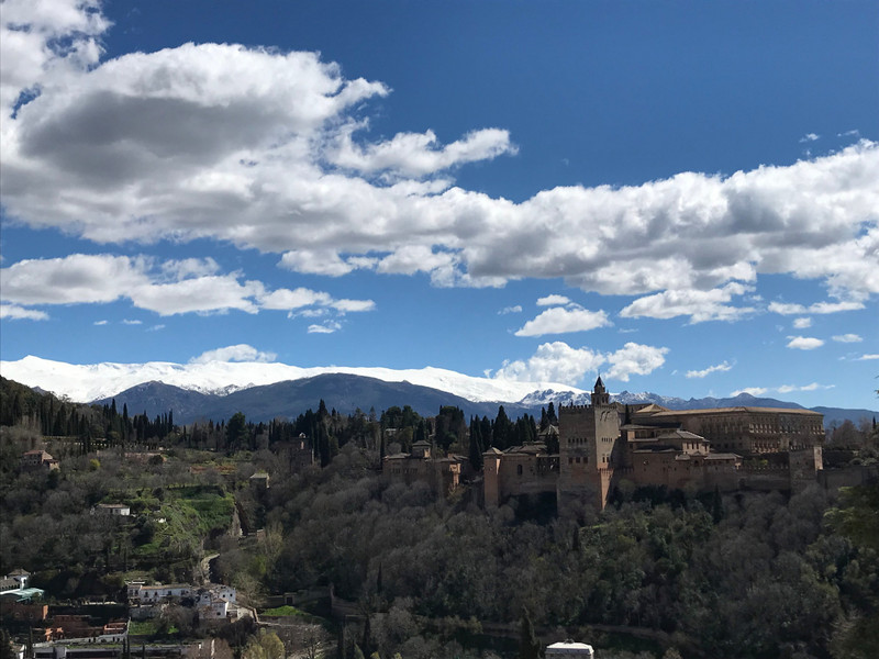 Alhambra during the day, with the Sierra Nevada range in the background