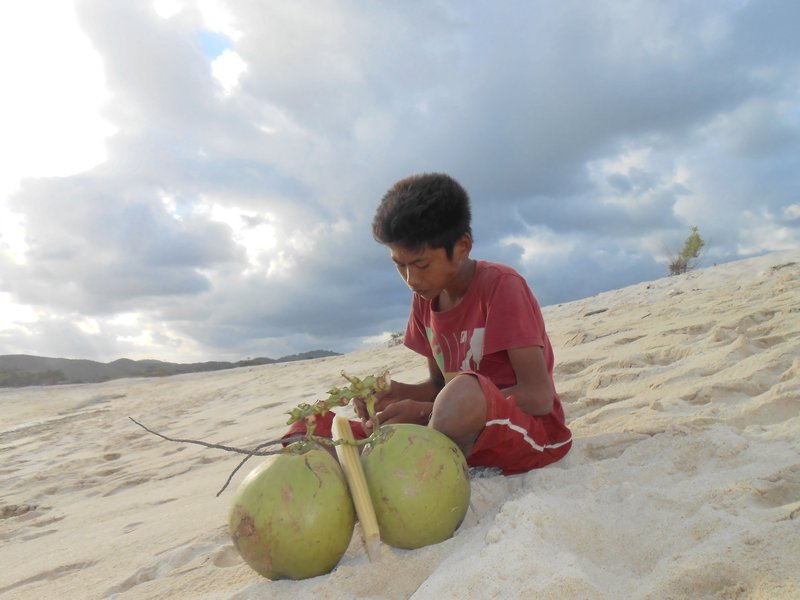 kid trying to sell his coconut