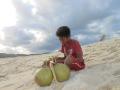 kid trying to sell his coconut
