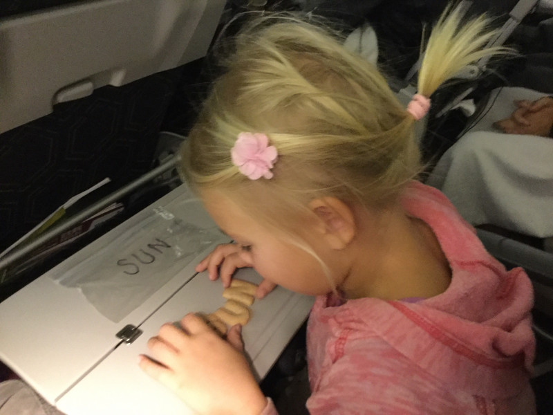 Practicing words with letter cookies on the plane ride over