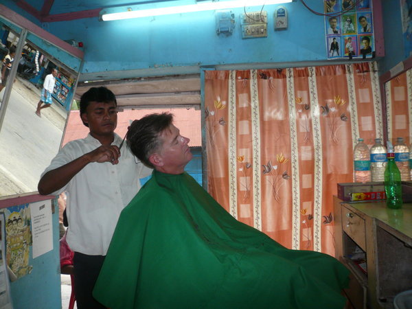Scott taking a risk at an Indian barber shop!