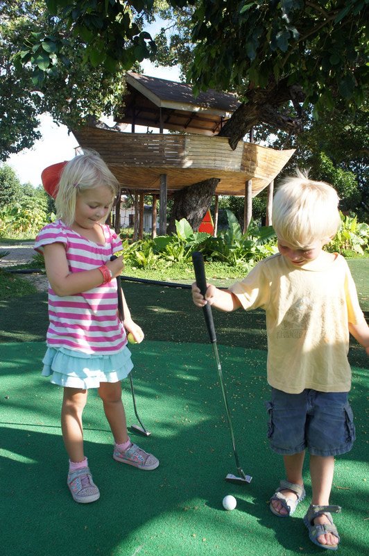 Mini golf, with the playground in the background