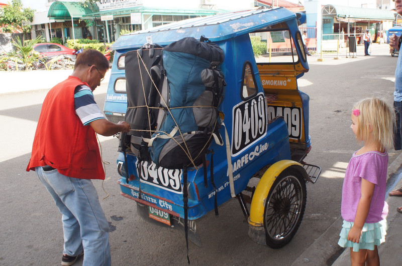 Strapping our luggage onto a tricycle in The Philippines