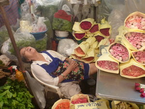 Tired woman at night flower market