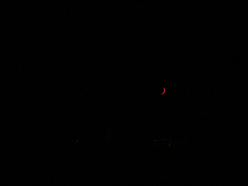 Bright red crescent moon
