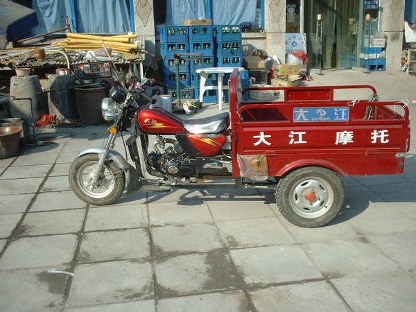 A three wheel red vehicle