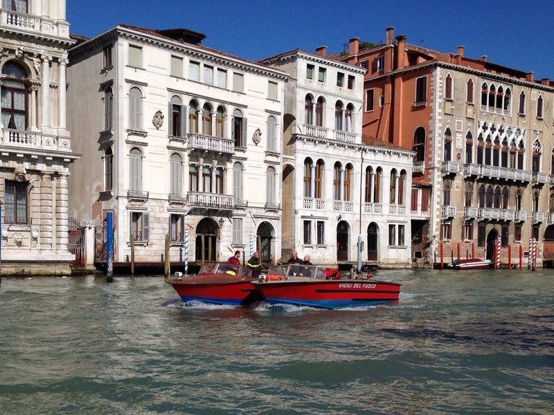 Venetian firemen in front of a palazzo on the grand canal