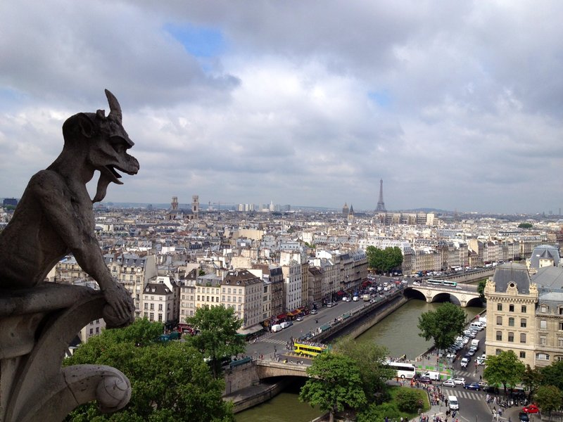 Gargoyle overlooks the Eiffel tower on Notre Dame
