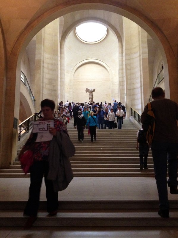 March up the stairs towards the Mona Lisa 