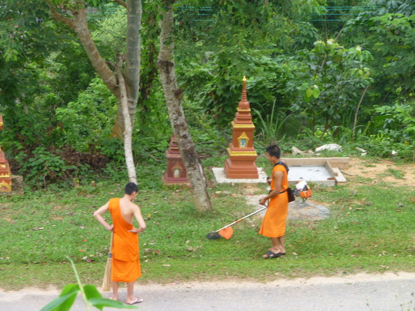 Monks strimming the lawn