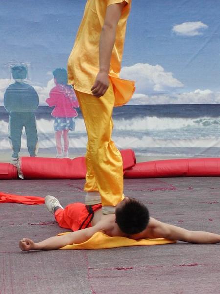 Kung Fu monk proving he can roll over glass