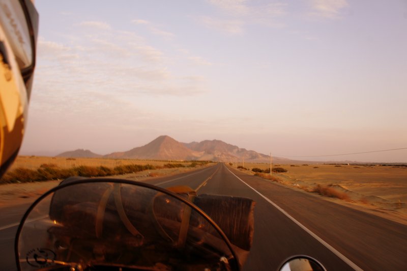 Dusk riding on Peruvian desert road
