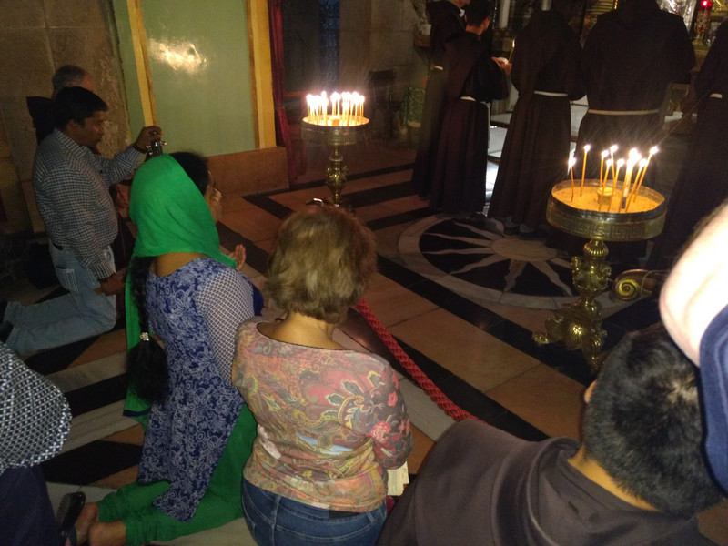 Gee (right) kneels at the altar in the church.