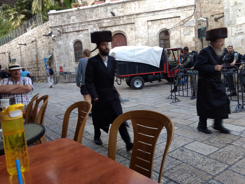 Orthodox Jews scurry through the Muslim section of the Old City.