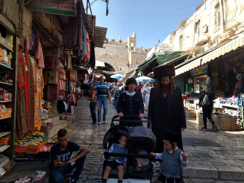 An orthodox family walking through the Muslim section.