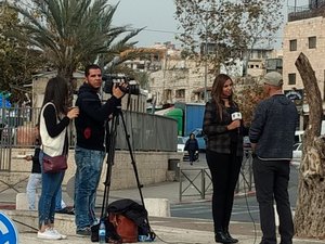 Journalist interviewing near Damascus Gate.