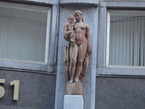 Marble sculpture on the side of a building.