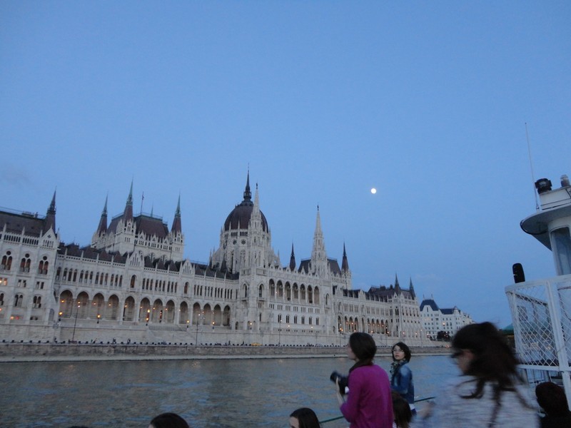 The moon above the Parliament as light fades away.