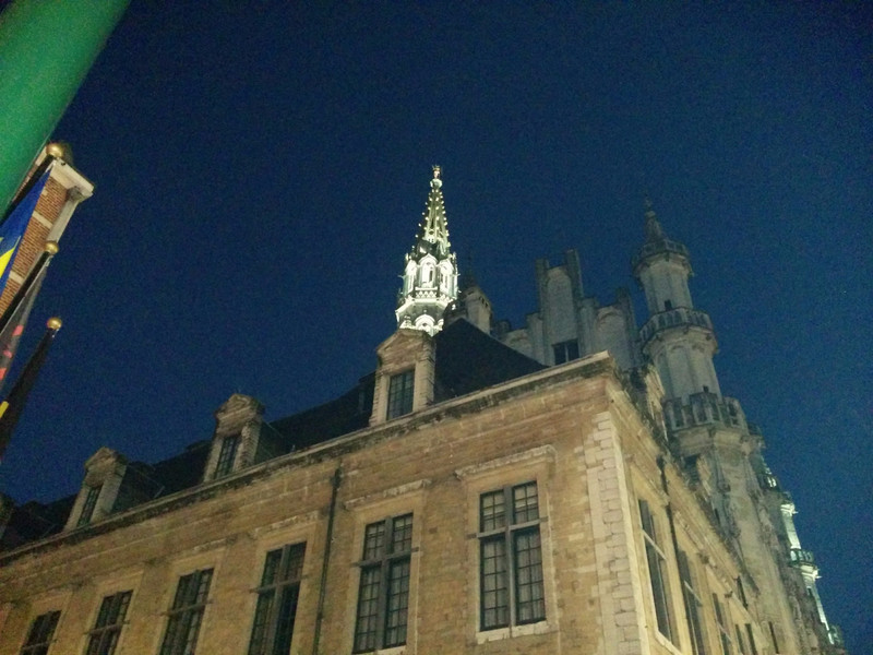 Lighted steeple in the Grand Place.