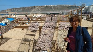 Gee next to the drying fish in Nazare.