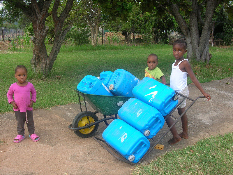 Simelane family--carrying water