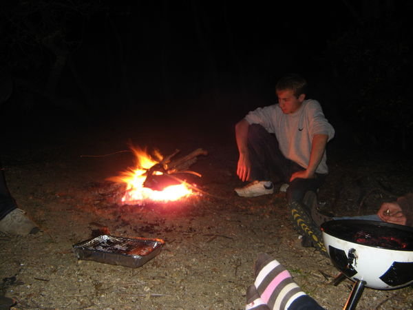 Frank beside campfire on the beach