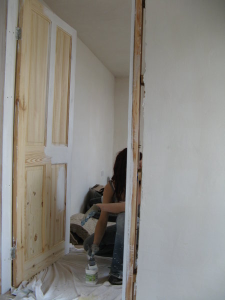 Emma priming a bedroom door