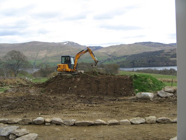 Digger levelling the hill