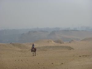 Lone Rider and Cairo at the edge of the Pyramids
