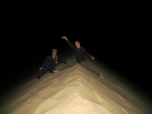 on top of sand dune in the pitch dark