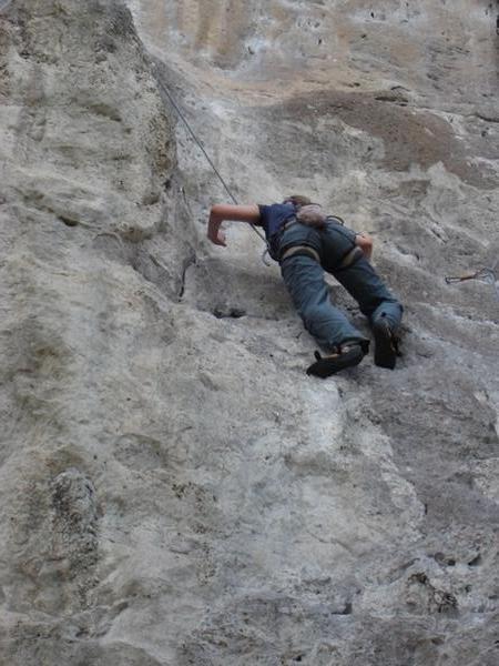 Gem climbs a cliff