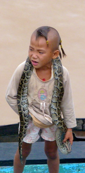 Boy on the river with a snake