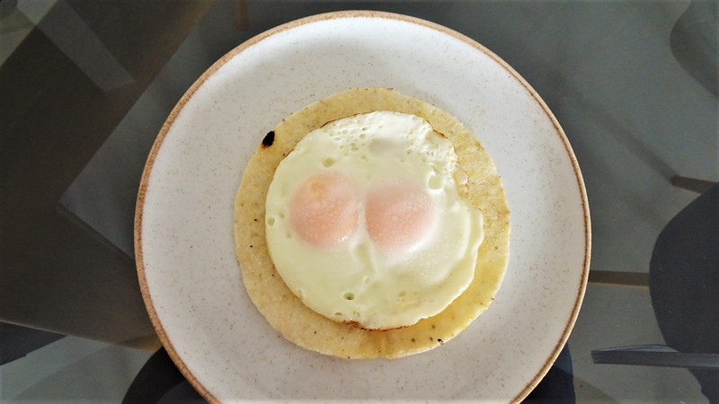 Arepa with fried eggs on top