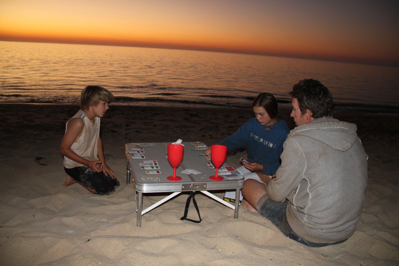 Playing Monopoly Deal at sunset on Yardie Creek Beach. Such class!