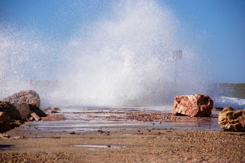A wave breaks on Learmonth jetty