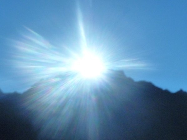 Sun peaking over Wayna Pichu