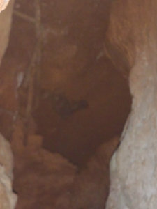 Old gun laying in the small cave