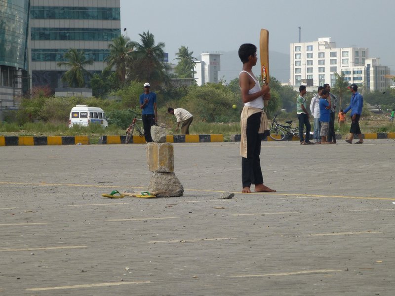 Dharavi kids play cricket - finance areas grows in ackground