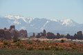 View of Arches NP with snow covered hills in the background