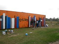Fellow volunteers painting books on the container