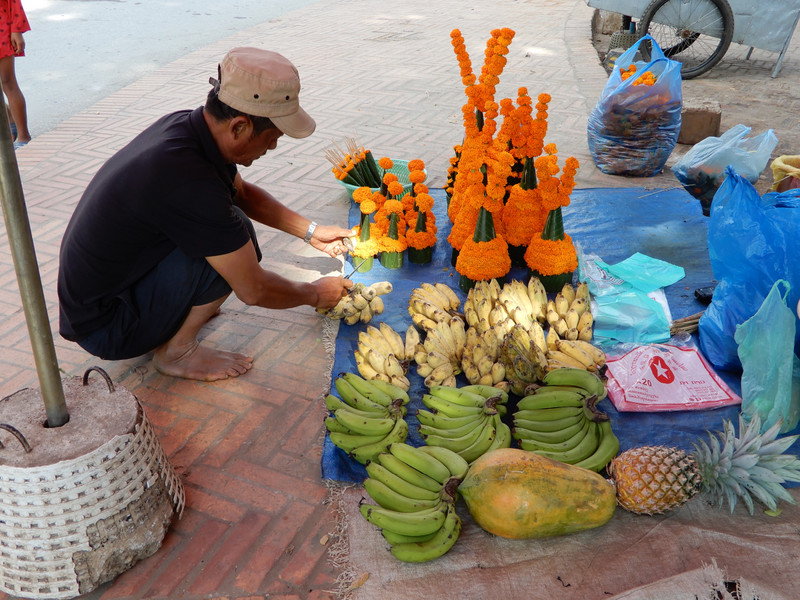 Vendor Selling Fruit and Offerings