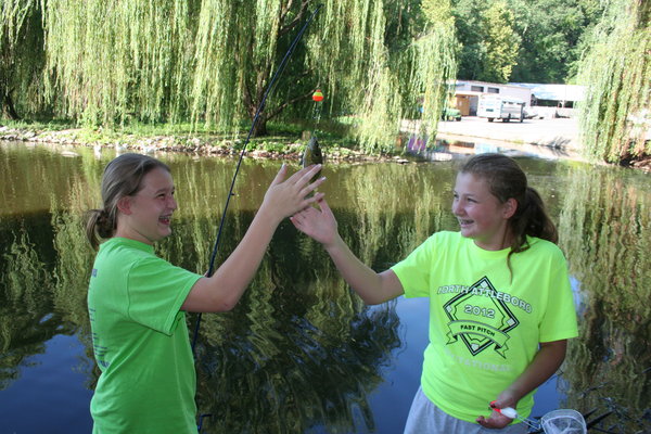 Abby and Sabrina petting the fish