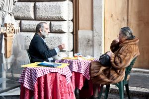 Old couple dining in the street